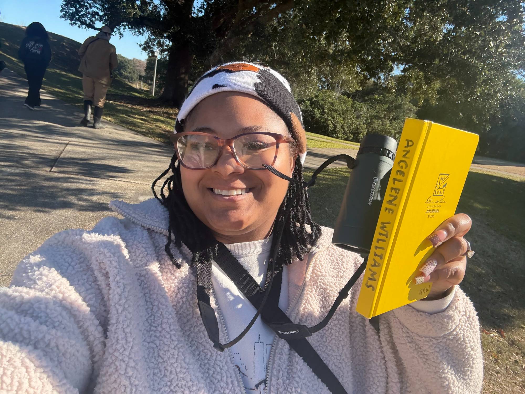 Angelene Williams with binoculars and a notebook Angelene Williams with binoculars and a notebook