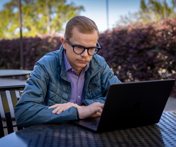 A MAN AT A COMPUTER