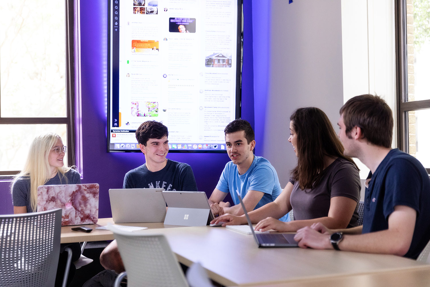 Group of students in the SMAC lab Group of students around a table